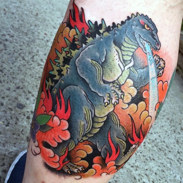 Old cartoons like multicolored Godzilla tattoo on leg