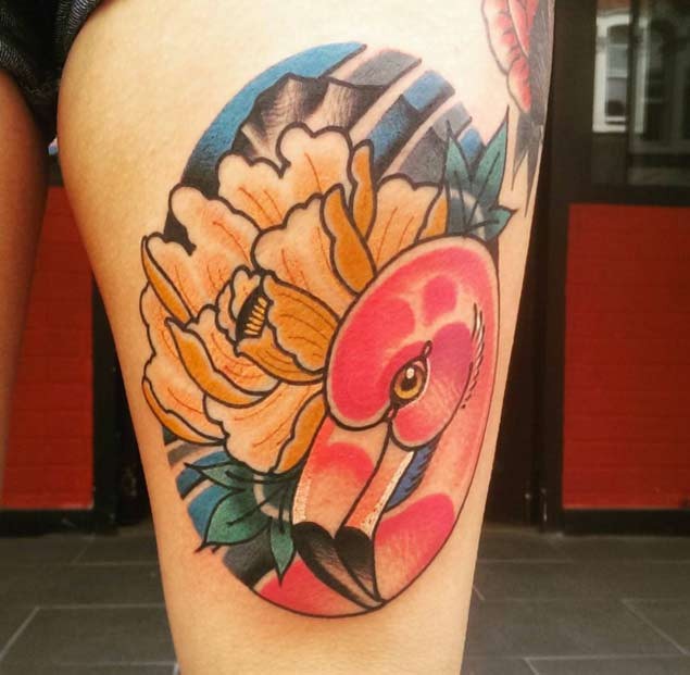 Old cartoons style colored flamingo tattoo on thigh combined with beautiful flower