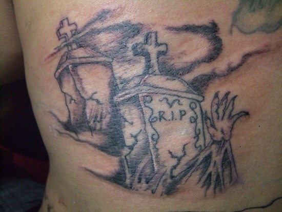 Old cracked graves with arm in graveyard mystical creepy tattoo