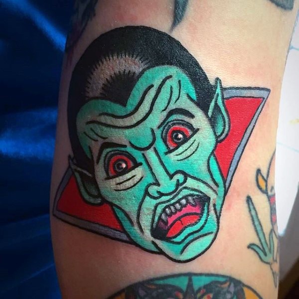 Old horror cartoon style unique colored vampire tattoo on arm