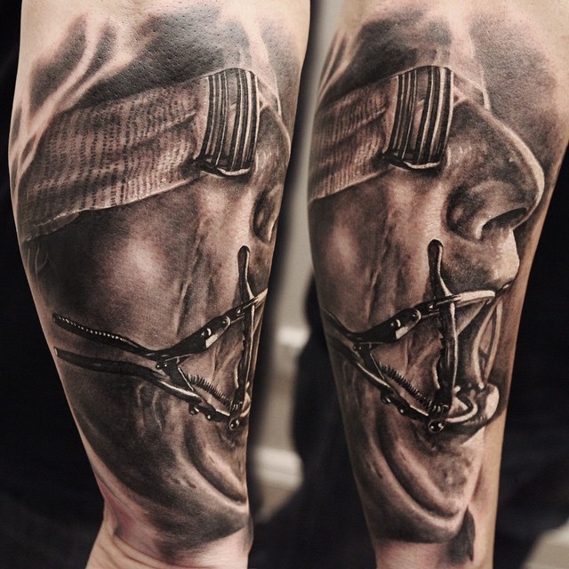 Old horror movie style very detailed man portrait tattoo on arm
