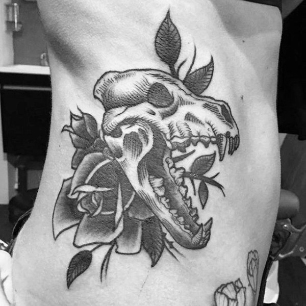 Old looking black ink side tattoo of animal skull with rose