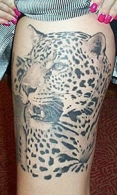 Old photo like black and white realistic leopard  tattoo on thigh
