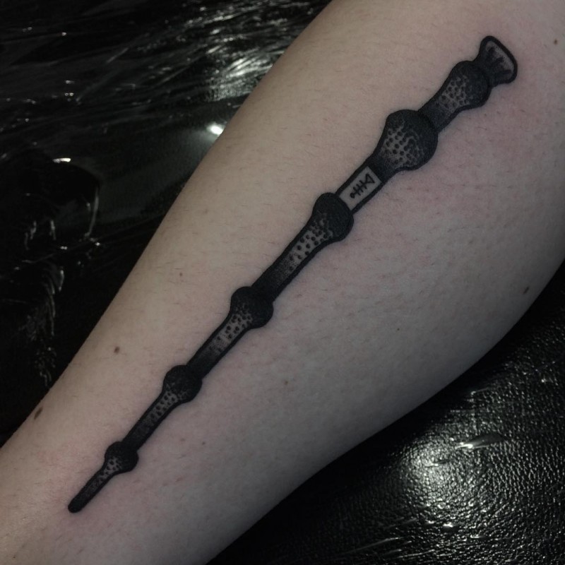 Old school big black ink wizard stick on forearm tattoo