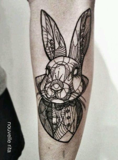 Old school black ink ornamental forearm tattoo of rabbits portrait