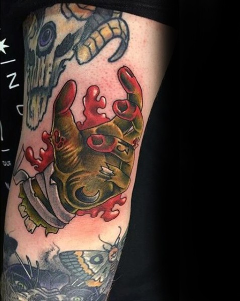 Old school cartoon colored zombie hand tattoo on arm with number