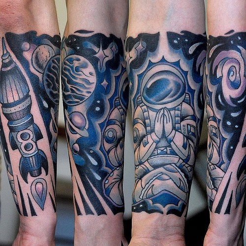 Old school cartoon style colored arm tattoo of astronaut with rocket and solar system