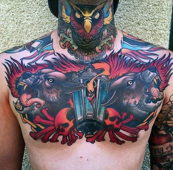Old school colored hell dogs tattoo on chest combined with bones and street lighter