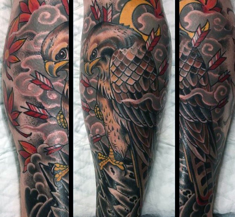 Old school colored leg tattoo of eagle with arrows and leaves