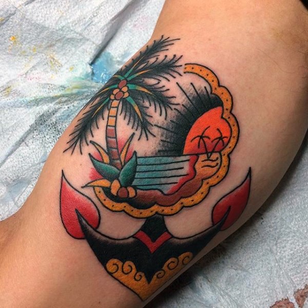 Old school colored little nautical tattoo with ocean and anchor on arm