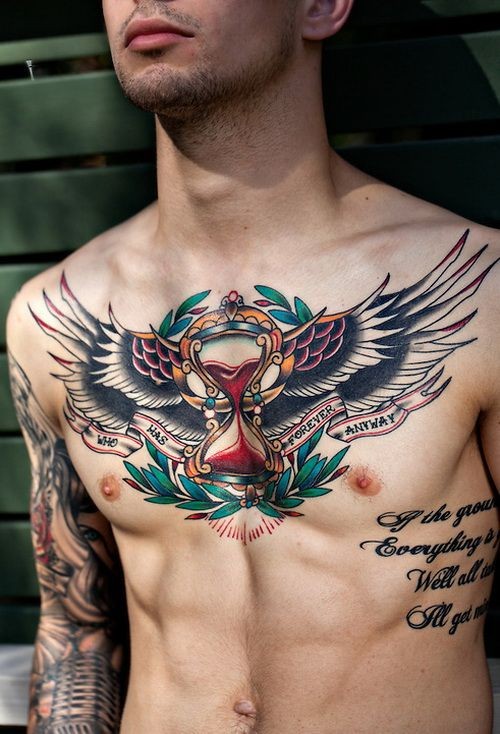 Old school colored sand clock with wings tattoo on chest with lettering