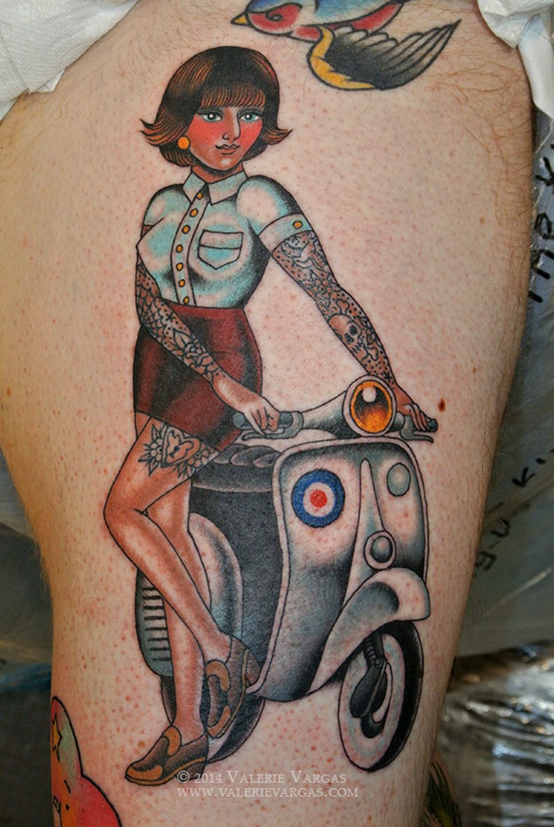 Old school colored woman with scooter tattoo on shoulder