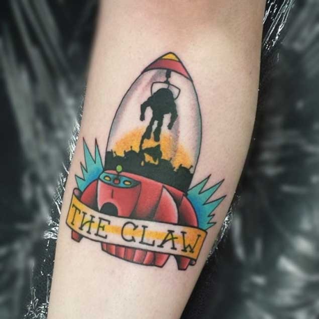 Old school colorful toy rocket tattoo on forearm with lettering