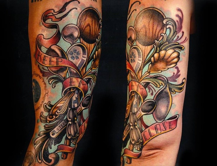 Old school colorful various spoons tattoo on arm with lettering