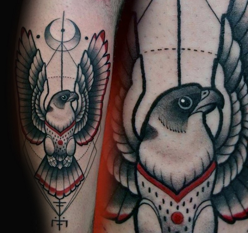 Old school cult like colored eagle tattoo on forearm with mystical ornaments