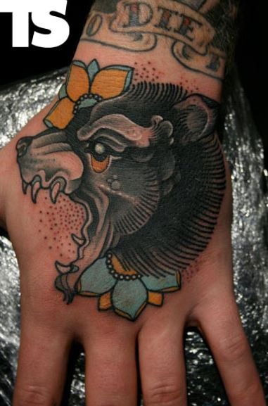 Old school head of a bear tattoo on hand