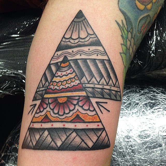 Old school homemade colored triangles tattoo stylized with various ornaments