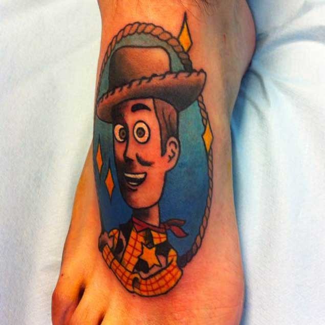 Old school multicolored foot tattoo of Toy Story hero with stars