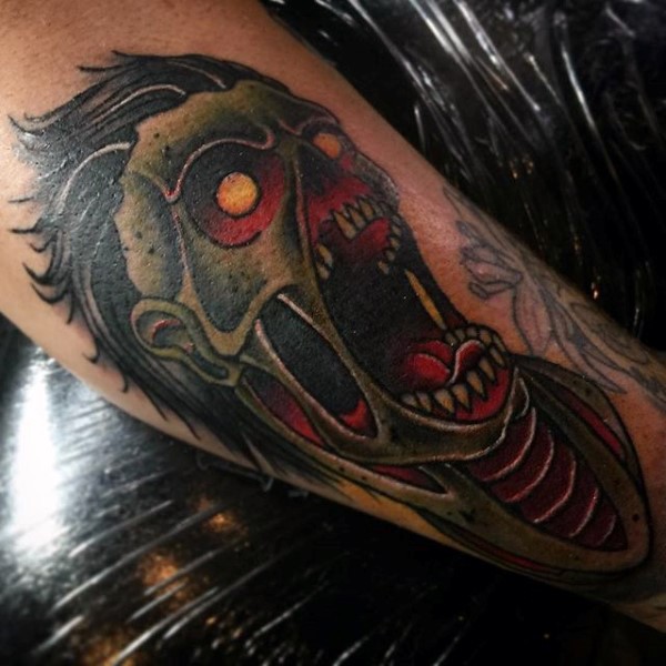 Old school multicolored forearm tattoo of creepy zombie