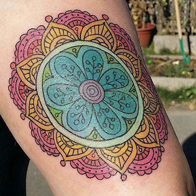 Old school multicolored ornamental flower tattoo