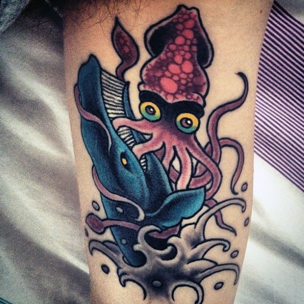 Old school multicolored squid with whale tattoo on arm