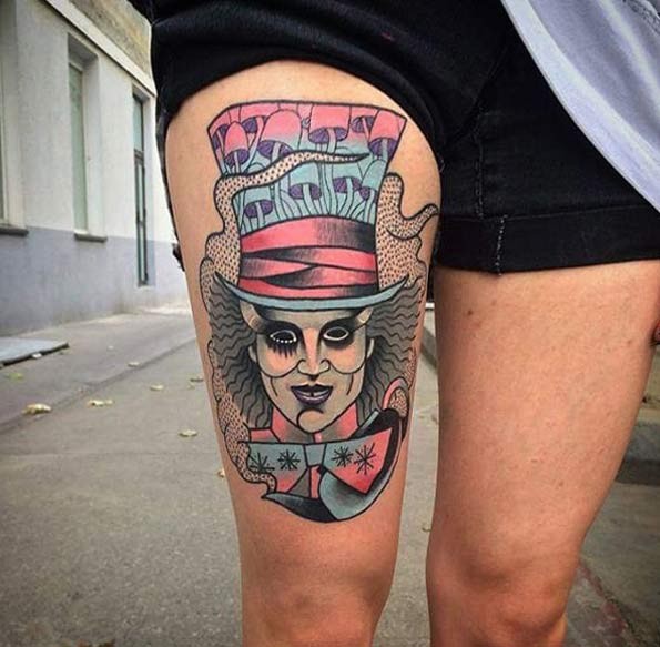 Old school multicolored thigh tattoo of hero from Alice in wonderland