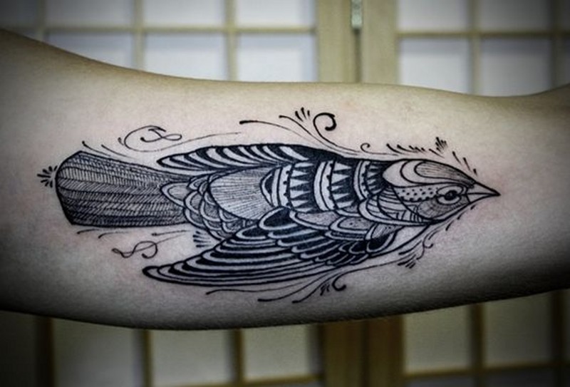 Old school painted black ink bird tattoo on arm
