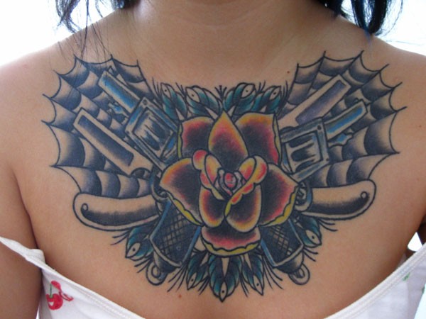 Old school red rose with guns chest tattoo