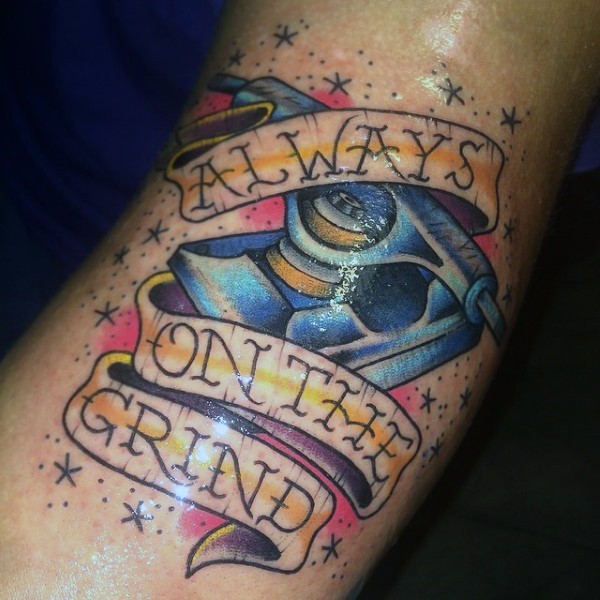 Old school skateboarding style colored arm tattoo with lettering