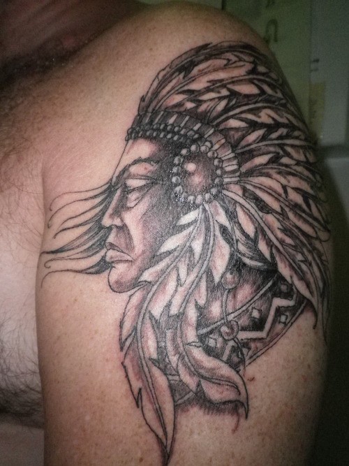 Old school style 3D very detailed black ink sad Indian tattoo on shoulder