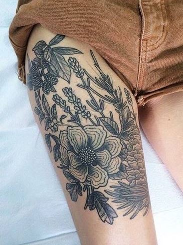 Old school style black and white flowers tattoo on thigh
