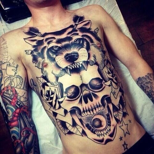 Old school style black and white human skull with roses tattoo on chest stylized with wolf hemet