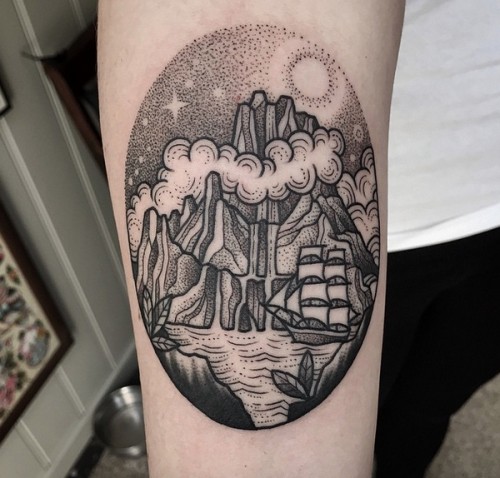 Old school style black ink nautical themed forearm tattoo of mystic island with sailing ship