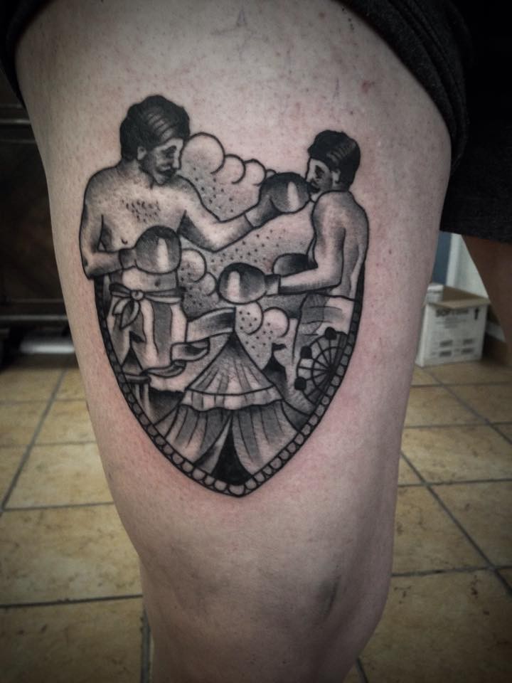 Old school style circus boxers framed thigh tattoo