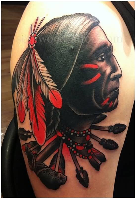 Old school style colored American native Indian portrait tattoo on shoulder with arrows and axe