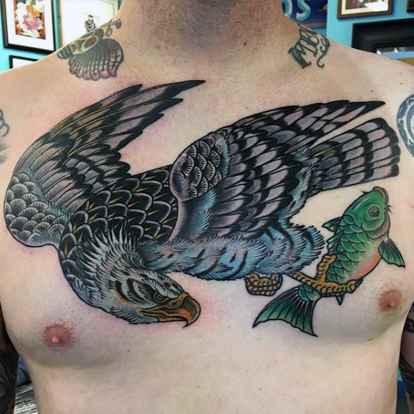 Old school style colored and detailed big eagle with fish tattoo on chest