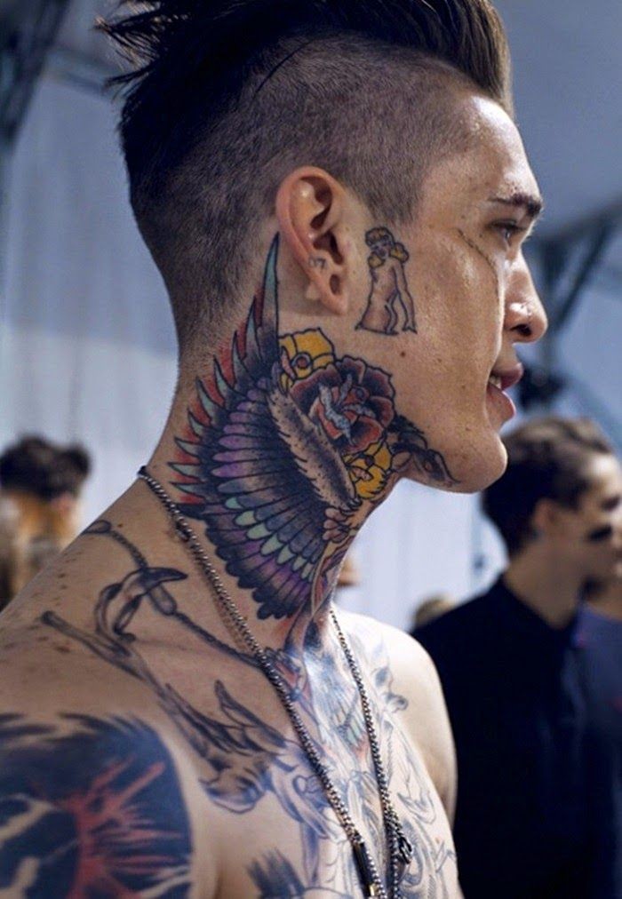 Old school style colored angel wings tattoo on neck stylized with multicolored flowers