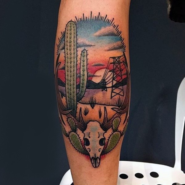 Old school style colored arm tattoo of desert with cactus and animal skull
