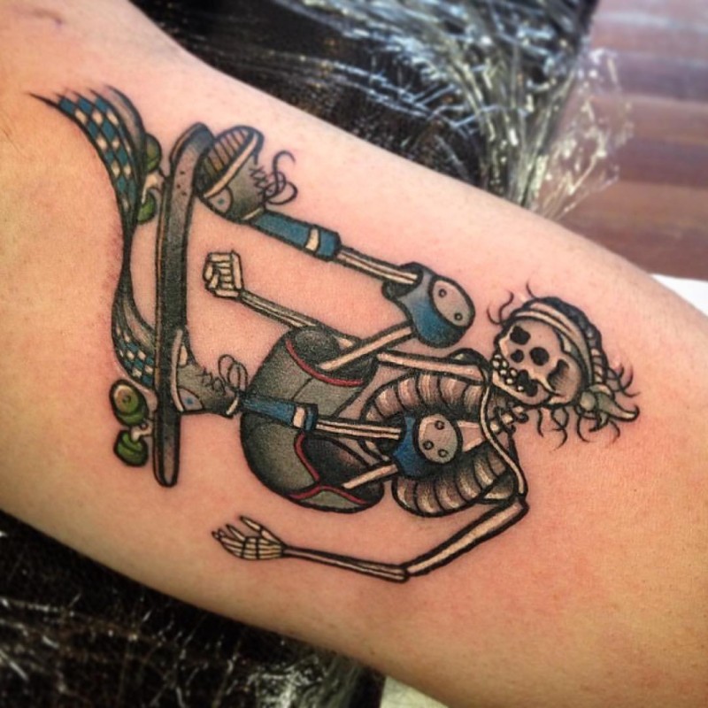 Old school style colored arm tattoo of skeleton skateboarder