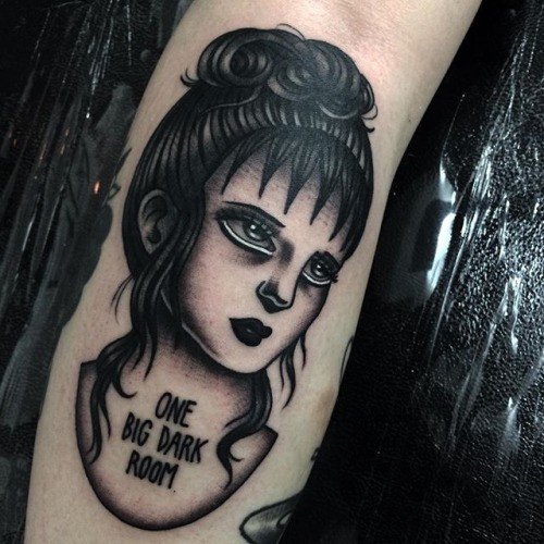 Old school style colored arm tattoo of woman face with lettering