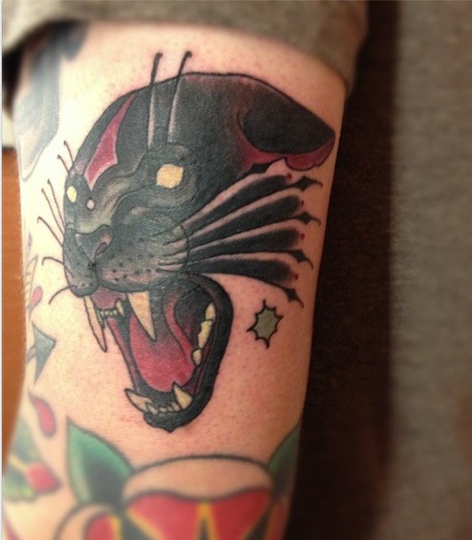 Old school style colored arm tattoo of roaring black panther with stars