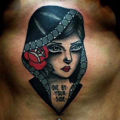 Old school style colored belly tattoo of woman with hood and lettering