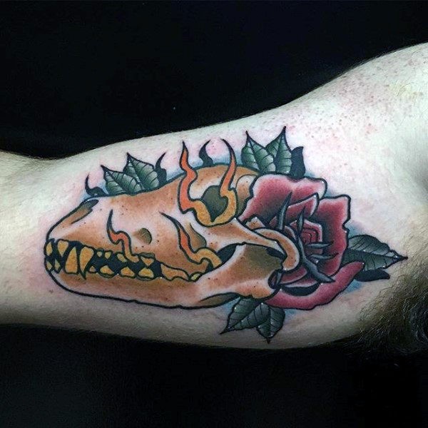Old school style colored biceps tattoo of animal skull with rose
