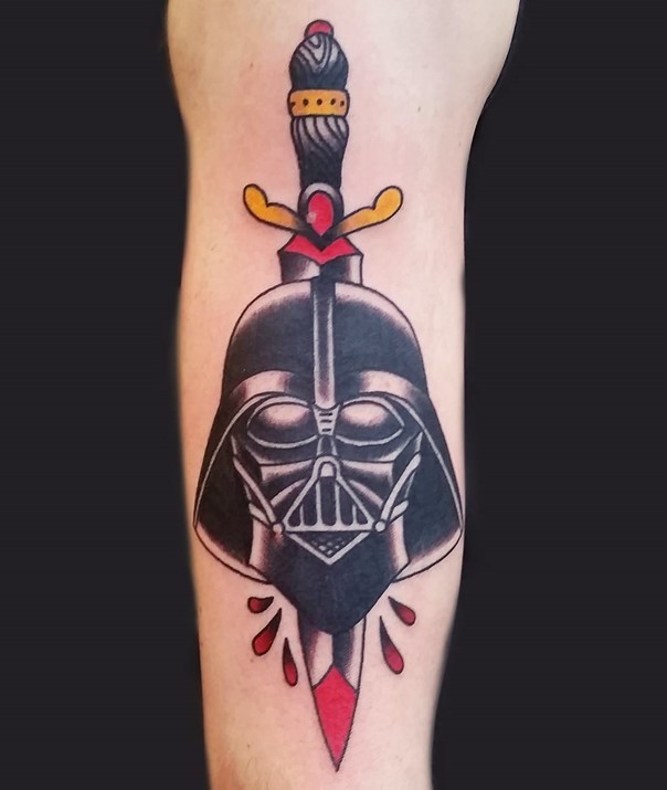 Old school style colored bloody dagger in Darth Vaders helmet tattoo on forearm