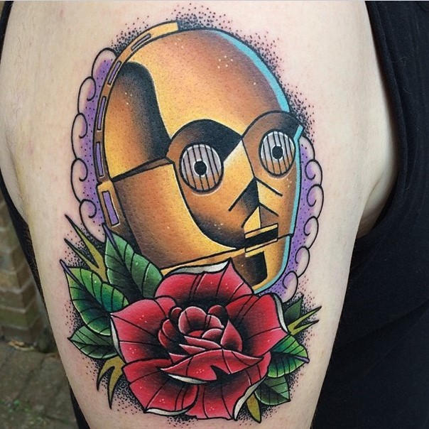 Old school style colored C3PO portrait tattoo on shoulder stylized with flowers