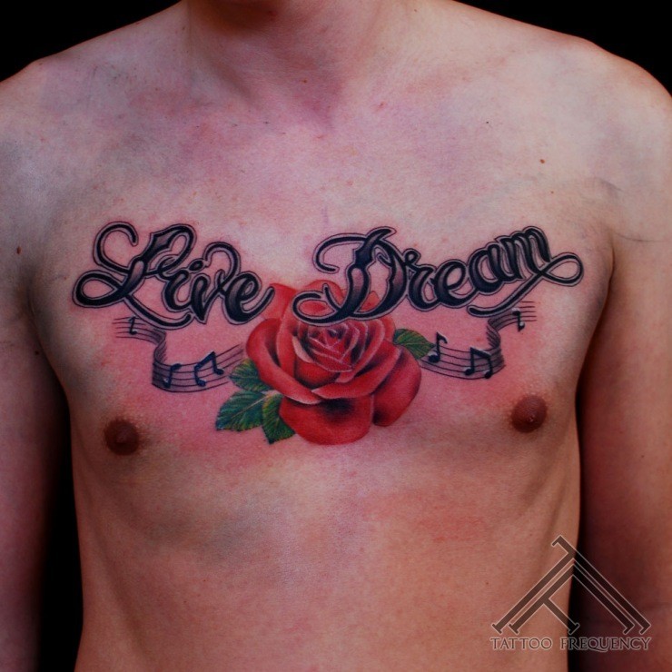 Old school style colored chest tattoo of red rose with notes and lettering