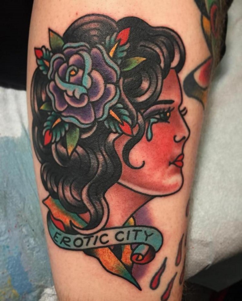 Old school style colored crying woman tattoo on arm with lettering