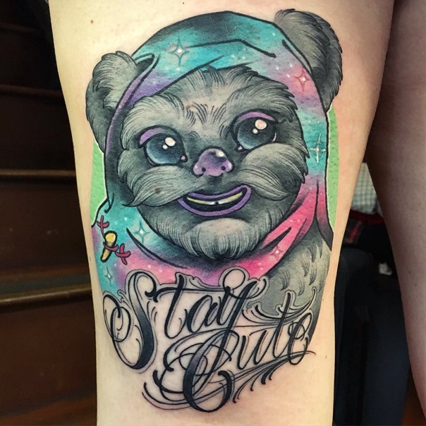 Old school style colored cute ewok portrait tattoo on thigh with lettering