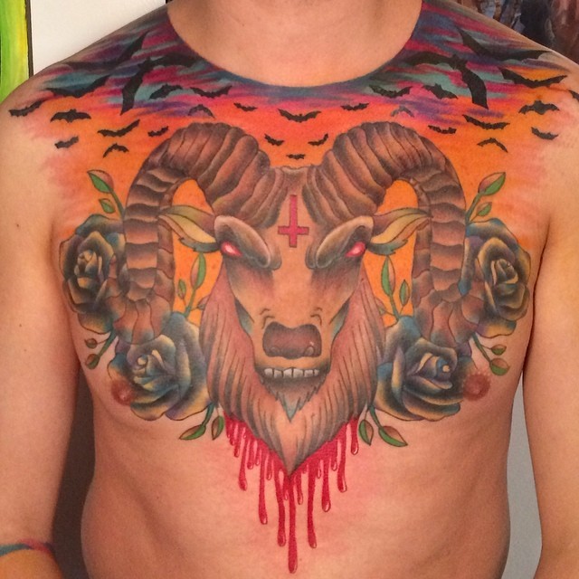 Old school style colored demonic bloody goat head tattoo on chest stylized with flowers and bats