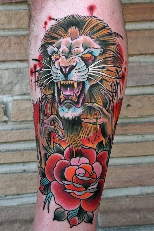 Old school style colored evil lion wizard tattoo on leg with rose